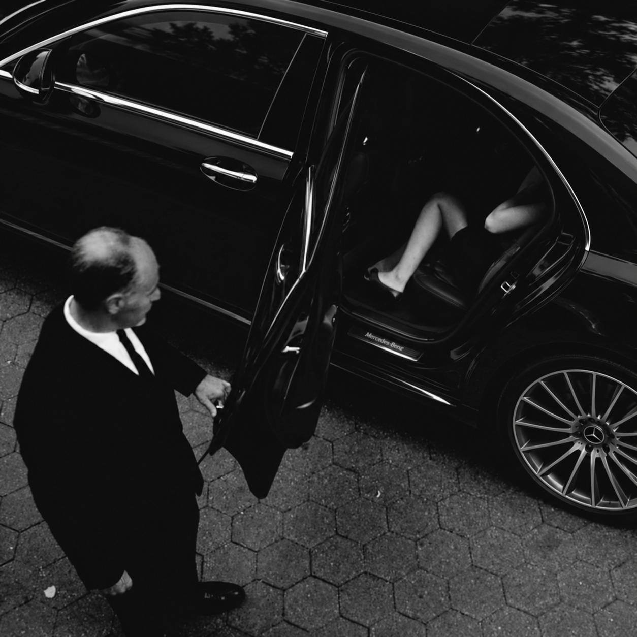 Chauffeur assisting passenger